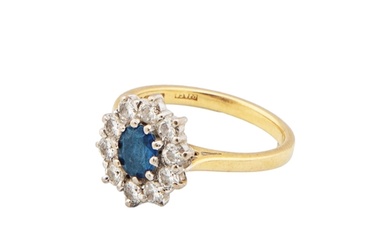 A Sapphire and diamond cluster ring The oval mixed cut sapph...