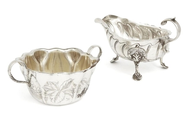 A Victorian Irish silver sauce boat Dublin, 1898, Charles Lambe, raised on three shell and foliate shouldered feet, the fluted body to a double scroll handle with foliate thumbpiece, 16.6cm long (inc. handle), together with an American silver sugar...