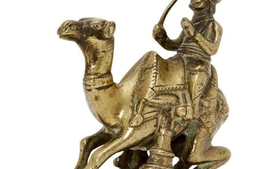 A brass figure of a camel driver,...