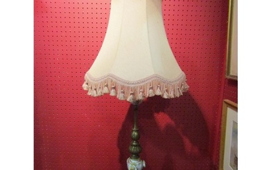 A brass table lamp on turned and ceramic column with applied...