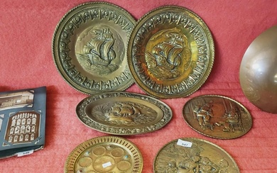 A collection of 5 brass wall hanging plates, the larger bein...