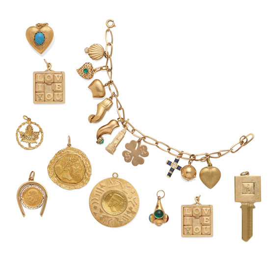 A gold charm bracelet with a collection of eight loose charms and a gold key