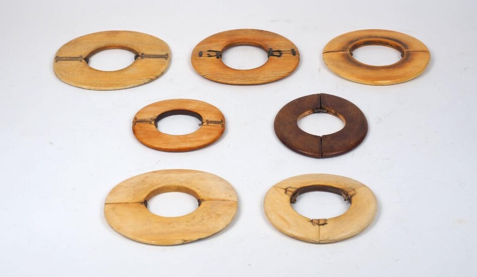 A group of mixed African ivory bangles, 19th century, of varying patinas an sizes, of round and lipped carved form, one of navette form, 10cm to 13.5cm long approx (9)