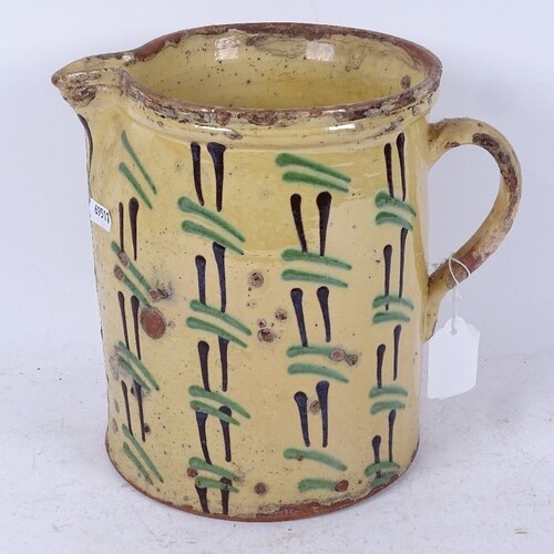 A large 19th century slip ware pottery jug, height 22cm