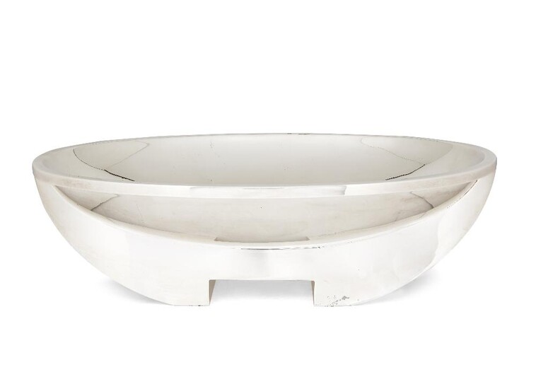 A large contemporary silver centrepiece dish by Asprey, London, 2008, of oval form, the plain body raised on a longitudinal curving foot to flat base designed with rectangular cut-out, 41.5cm long, 30.5cm wide, 12.8cm high, gross weight approx. 115oz