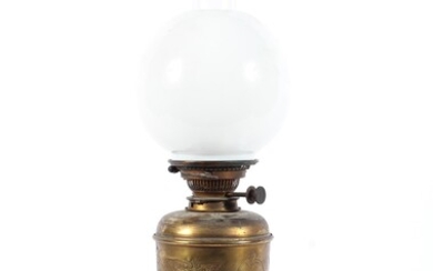 A late 19th century brass oil lamp, the urn shaped body with embossed foliate decoration