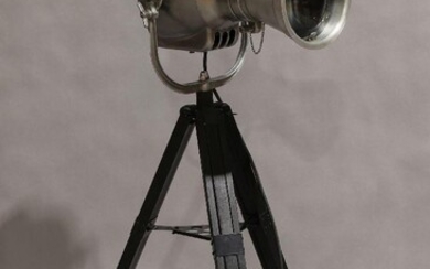 A modern chrome floor lamp, in the form of a vintage theatre spot light, marked 'Strand Electric', raised on adjustable stand It is the buyer's responsibility to ensure that electrical items are professionally rewired for use.