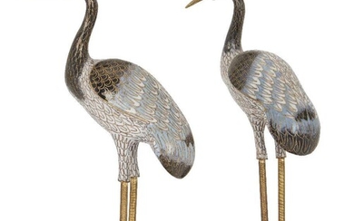 A pair of Chinese cloisonnÃ© enamel figures of storks, 20th century, on stained wood oval stands, storks 22.6cm and 23.6cm high, total 25cm and 26cm high (2)