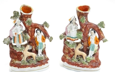 A pair of Staffordshire figural spill vases with a man