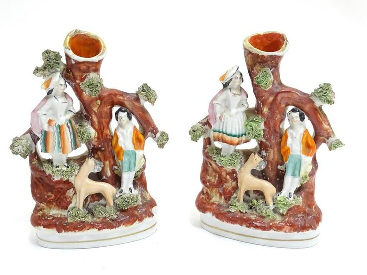 A pair of Staffordshire figural spill vases with a man