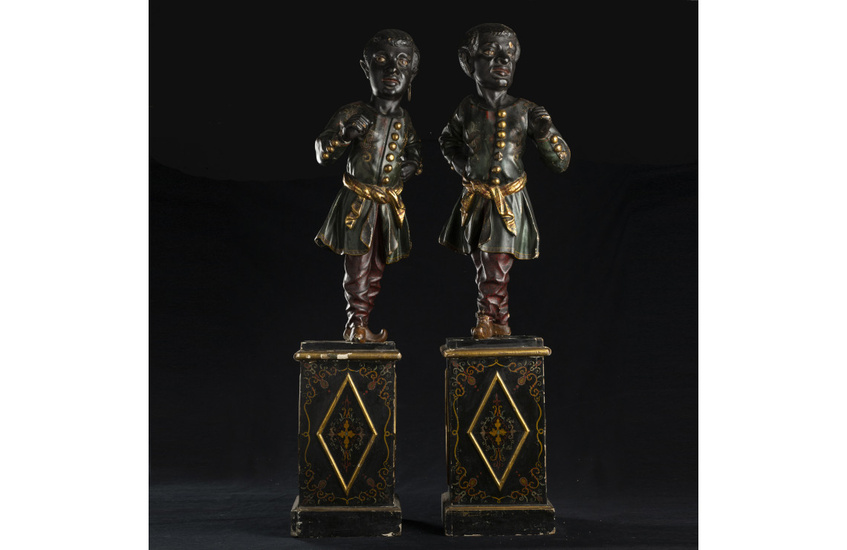 A pair of blackamoors in carved, lacquered and gilded wood