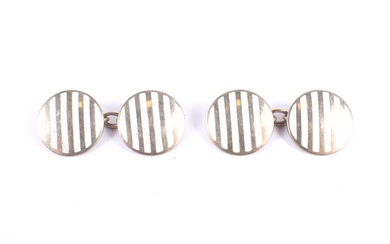 A pair of early 20th century gold and white enamel round twin-panel cufflinks.