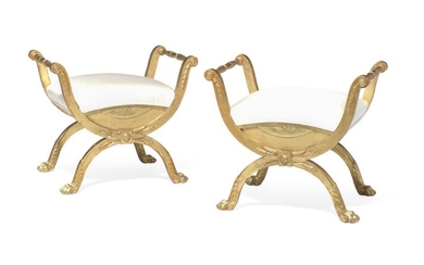 A pair of late Gustavian giltwood stools each with X-shaped legs and animal paws joined by profiled stretcher. Stockholm, late 18th century. (2)