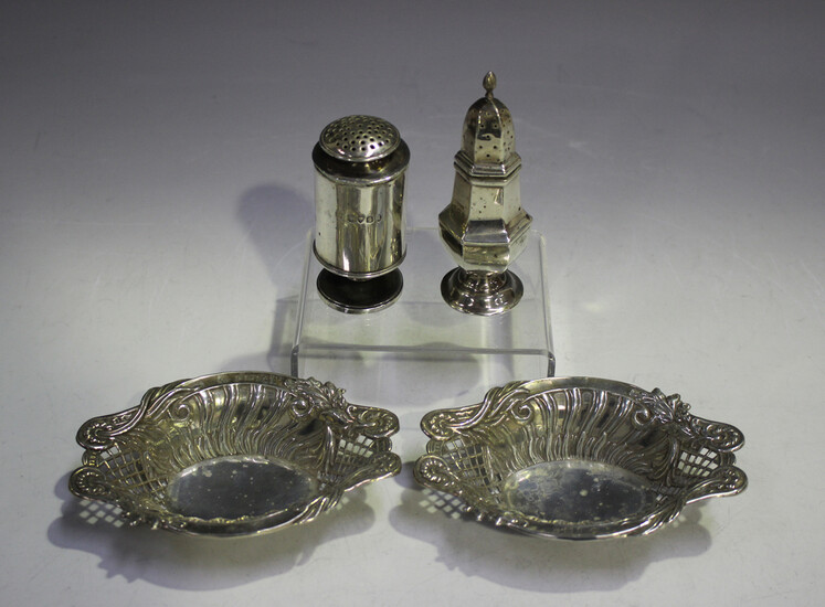 A pair of late Victorian silver oval bonbon dishes, each decorated in relief with scrolling leaf and