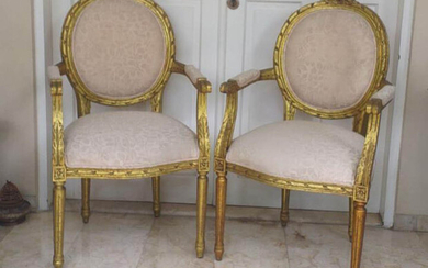 A pair of modern French Style gilt armchairs