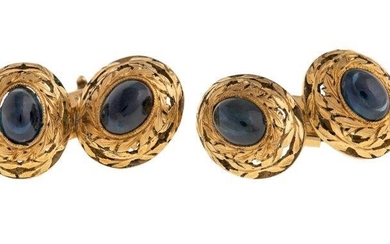 A pair of sapphire cufflinks, each oval link centring on a cabochon sapphire to an open work leaf surround, c.1960, case stamped Bulgari
