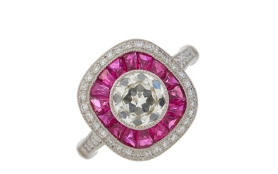 A platinum circular-cut diamond and calibre-cut ruby cluster...