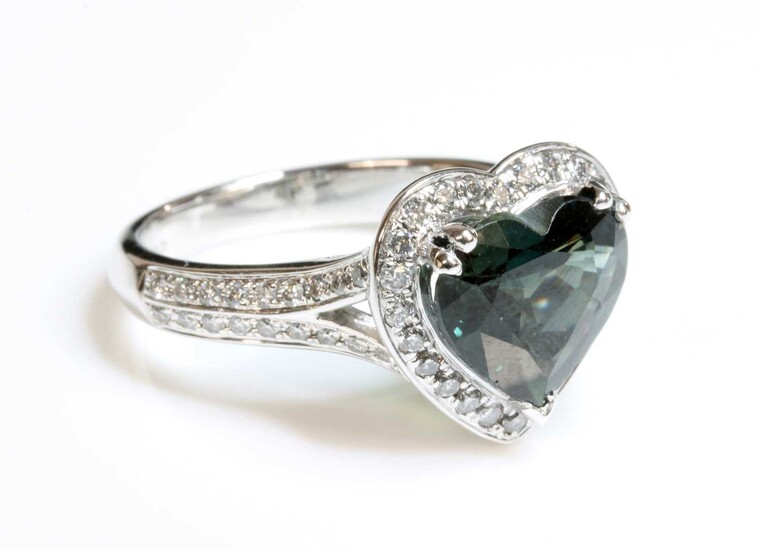 A platinum green sapphire and diamond heart-shaped halo cluster ring
