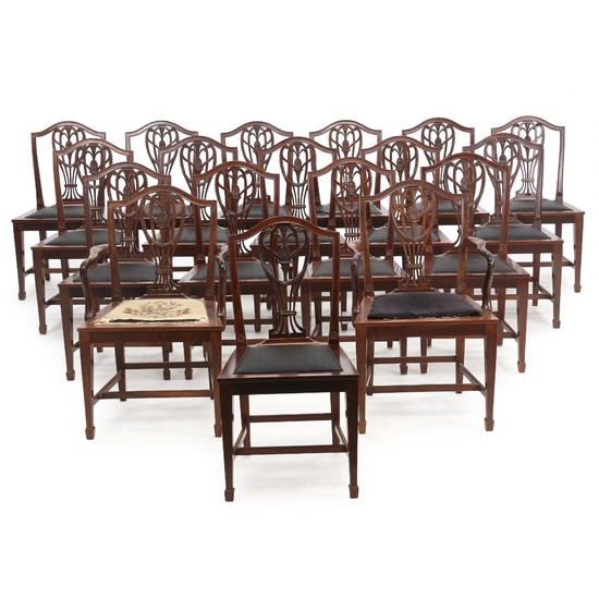 A set of 18 English mahogany dining chairs, heeof a pair of armchairs. Early 20th century. (18).