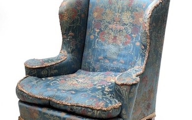 A silk upholstered wingback armchair