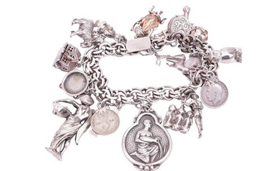 A silver charm bracelet with eighteen assorted charms and fobs including an owl, a stag, a country m