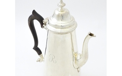 A silver coffee pot hallmarked London 1904, maker Goldsmiths...