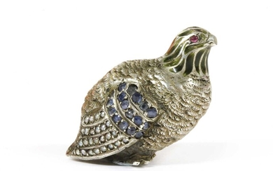 A silver sculpture of a partridge