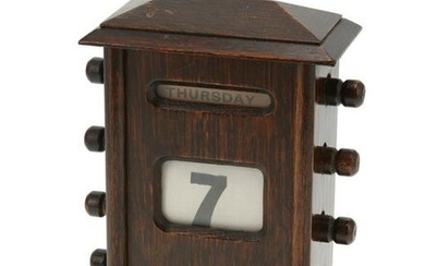 A wood perpetual desk calendar