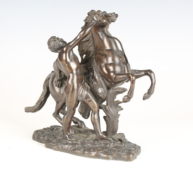 After Guillaume Coustou - a 19th century brown patinated cast bronze model of a Marly horse and atte