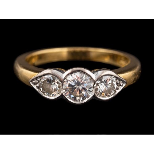 An 18 carat gold and diamond three stone ring,: the central ...