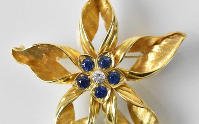 An 18ct yellow gold diamond and sapphire set flower brooch,...