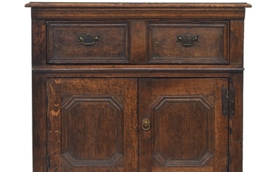 An 18th century and later oak cabinet, having a moulded top ...