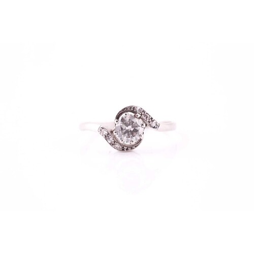 An Edwardian diamond crossover ring, the eight claw set roun...