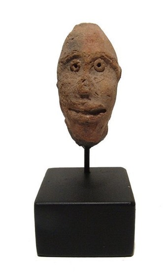 An Egyptian molded terracotta head of a man