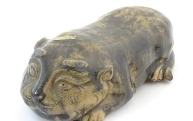 An Oriental model of a recumbent animal, possibly a