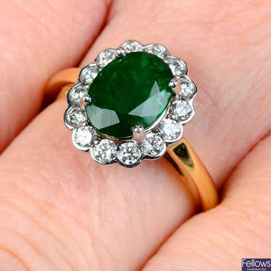 An emerald and brilliant-cut diamond cluster ring.