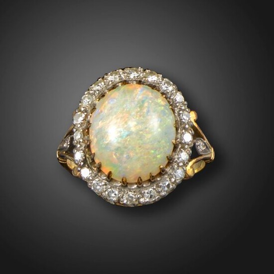 An opal and diamond cluster ring, the solid white opal...