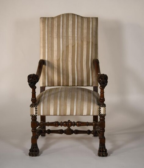 *Armchair in turned wood, carved lion head armrests. Striped fabric...