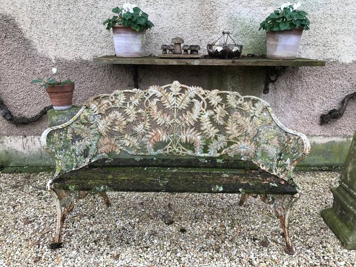 Cast iron garden bench decorated with an interlacing...