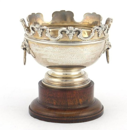 Circular silver trophy with lion mask handles by Adie