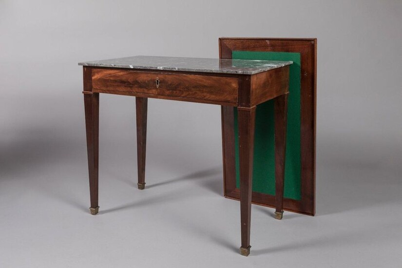 DIRECTORY MIDDLE TABLE in mahogany veneer, opening by a drawer in belt. It rests on sheathed legs. Covered with a grey Saint-Anne marble. It is surmounted by an adapted removable top. Double-sided it is darkened with a leather to make a writing table...