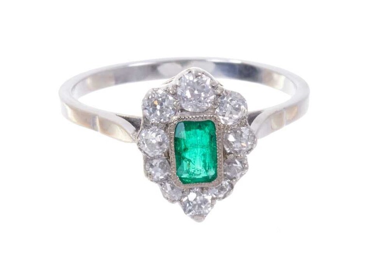 Emerald and diamond pear-shape cluster ring with a central mixed cut emerald surrounded by a border of old cut diamonds with pierced gallery on plain shank. Ring size N½.