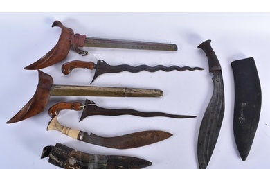 FOUR MIDDLE EASTERN KUKRI TYPE KNIVES. Largest 48 cm long. (...