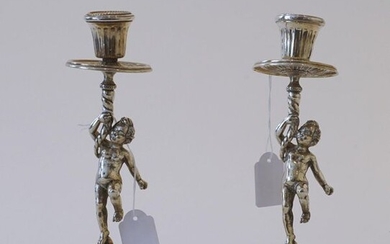 Pair of silver candlesticks, 800, decorated with putto, with loose fat catchers (bobeches), h. 23 cm, brand: Sorel, upper part slightly bent, appr. 770 grams (2x)