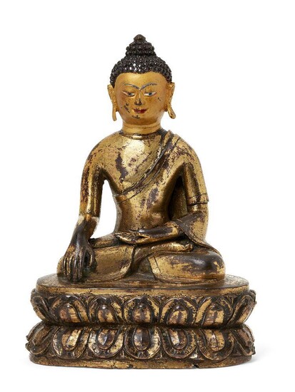 Property of a Gentleman (lots 36-85) A Mongolian Zanabazar School gilt-bronze figure of Shakyamuni Buddha, 18th century, seated in dhyanasana on a double lotus base, his right hand in bhumisparsha mudra and the left resting in his lap, incised with...