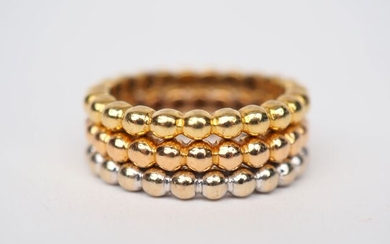 Set includes three three-tone gold rings with pearl row pattern....