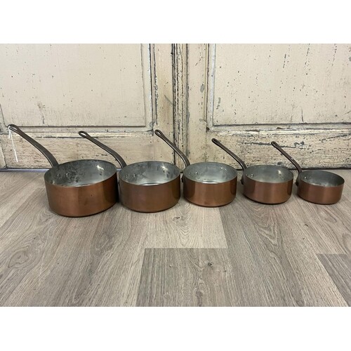 Set of five French copper sauce pans, iron handles stamped F...