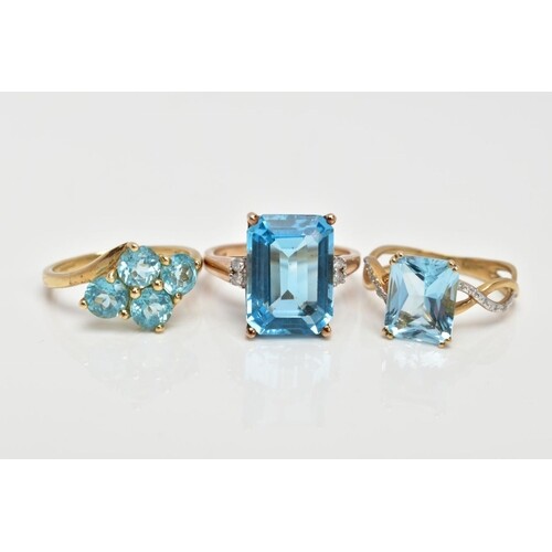 THREE 9CT GOLD TOPAZ DRESS RINGS, the first designed with a ...