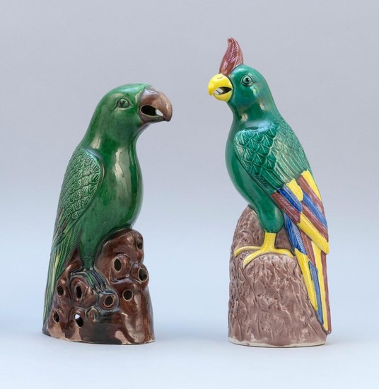 TWO CHINESE POLYCHROME PORCELAIN PARROT FIGURES Standing on aubergine rockery bases. Heights 10" and 11".
