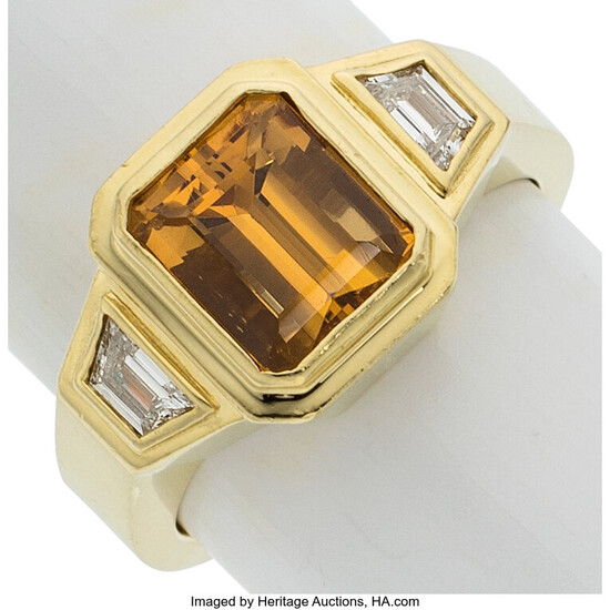 Topaz, Diamond, Gold Ring Stones: Emerald-cut topaz; trapezoid-shaped diamonds...